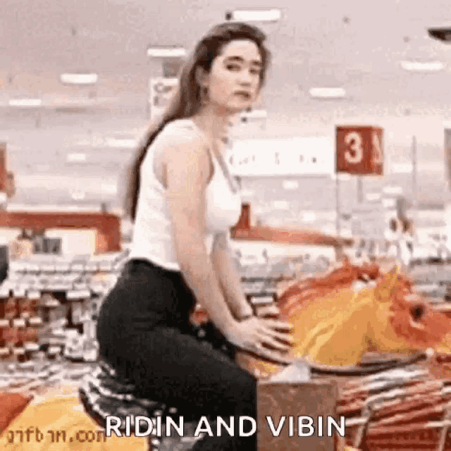 a woman is riding a mechanical horse in a grocery store .