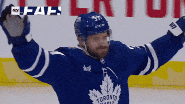 a hockey player for the toronto maple leafs celebrates