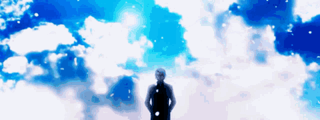 a man is standing in the clouds looking up at the sky .