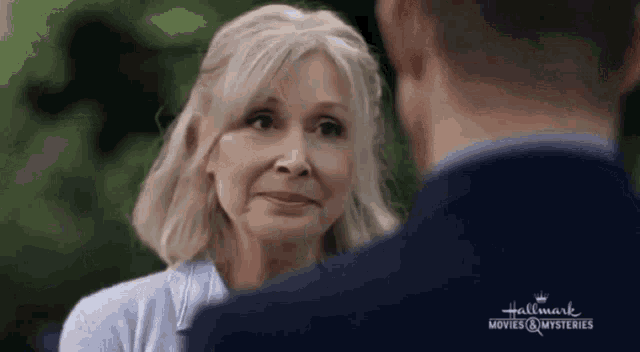 a man and a woman are looking at each other .