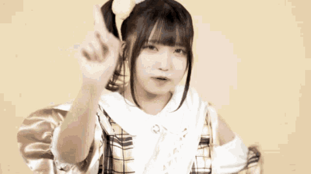 a girl with pigtails and a bow on her head is giving a high five