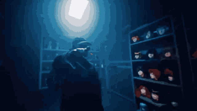 a person in a dark room with a shelf full of dolls