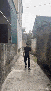 a man walking down a narrow alley with a cane