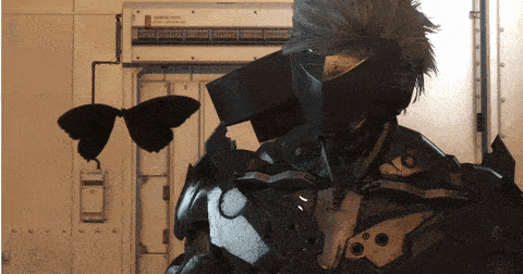 a man in a futuristic suit is standing in front of a wall with a butterfly hanging from it