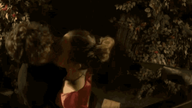 a man and a woman are kissing in a dark room