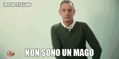 a man in a green sweater is making a funny face and says non sono un mago