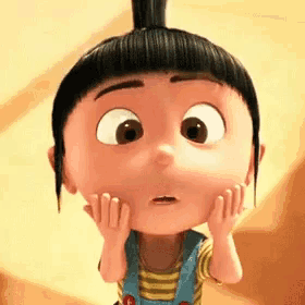 a little girl with a bun on her head is making a surprised face