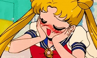 a close up of a cartoon character with her eyes closed and her hand on her face .