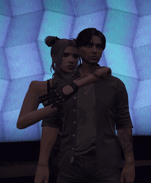 a man and a woman are posing for a picture in front of a purple wall