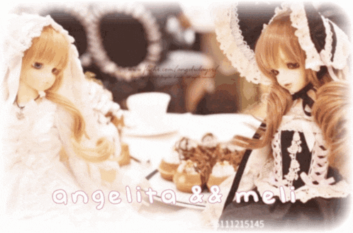 two dolls are sitting at a table with the words angelita & meli on the bottom right