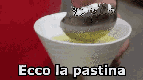 a person is pouring something into a cup that says ecco la pastina on it