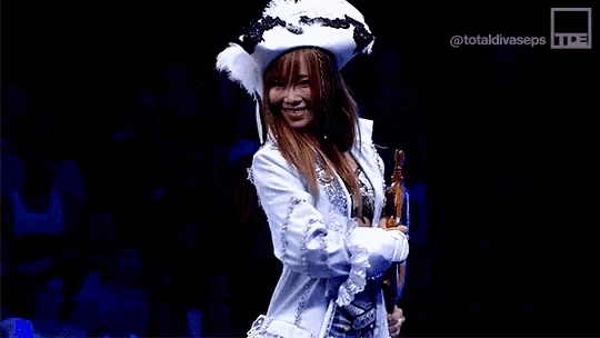 a woman in a pirate costume is holding a ship steering wheel in front of a totaldivaseps logo