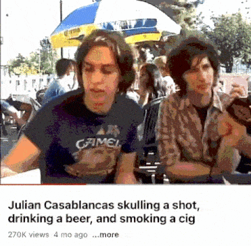 julian casablancas is drinking a beer and smoking a cigarette