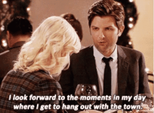 a man and a woman are sitting at a table and the woman is saying " i look forward to the moments in my day "