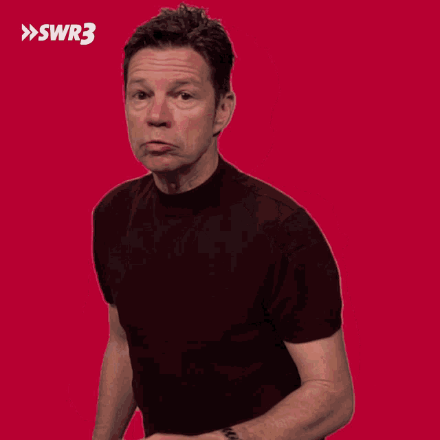 a man is covering his mouth with his hand and the word swr3 is on the bottom right