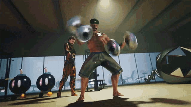 a man in a green hat holds a pair of dumbbells in a gym