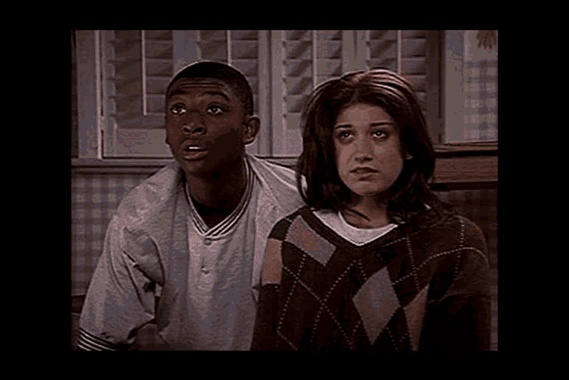 a man and a woman are sitting next to each other on a couch .