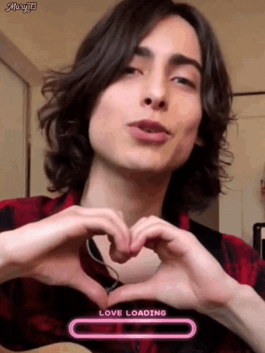 a young man is making a heart shape with his hands while a love loading bar is displayed in the corner .