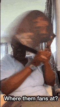 a woman brushing her hair with the words where them fans at on the bottom