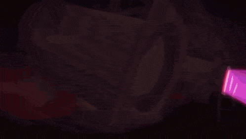 a close up of a purple light with a white light coming out of it