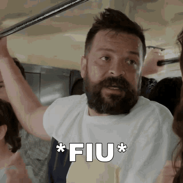 a man with a beard has the word fiu written in white