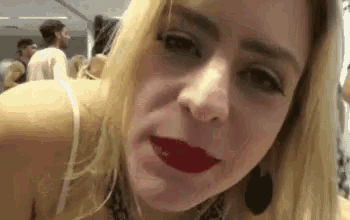a close up of a woman 's face with red lipstick on .