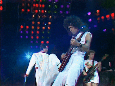 a man is playing a guitar on a stage