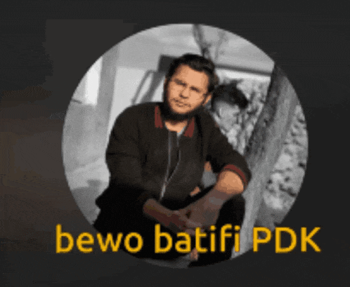 a man with a beard is sitting in a circle with the words bewo batifi pdk above him