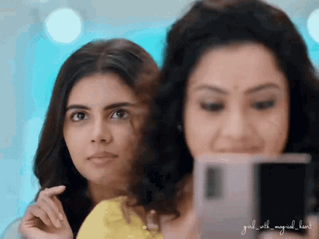 a girl with a magical heart takes a selfie with another woman