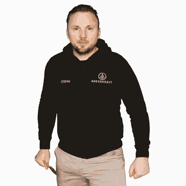 a man wearing a black jacket with the name stefan on the front