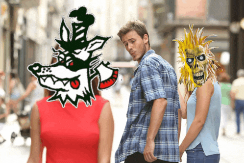 a man in a plaid shirt is standing next to a woman in a red dress and a cartoon wolf head