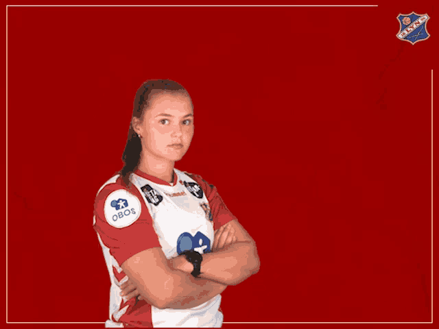 a girl wearing a red and white jersey with the word obos on the sleeve