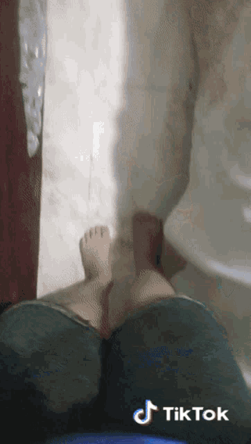 a person 's feet are shown with a tiktok watermark