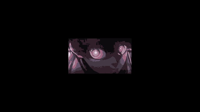 a blurry picture of a person in a dark room with a purple light coming out of their eyes .
