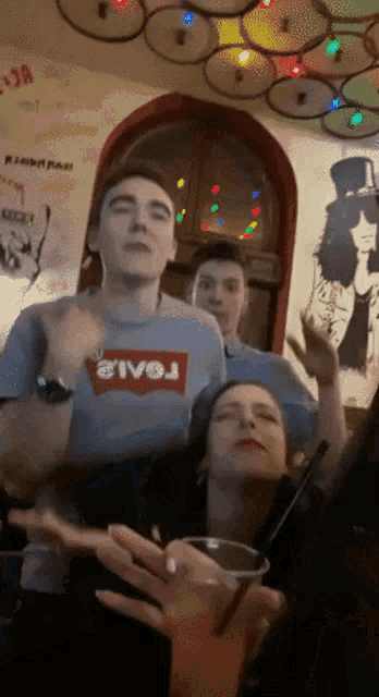 a man wearing a levi 's shirt is dancing in a room