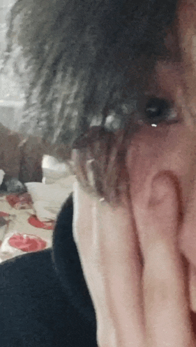 a close up of a person 's face with a tear coming out of it