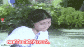 a woman in a white saree is smiling in front of a green background with the words ' imgflip.com ' on it