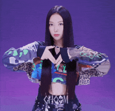 a woman with long black hair is wearing a crop top that says studio