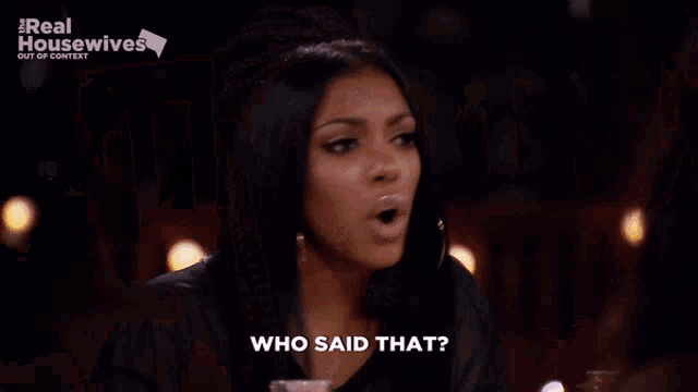 two women are sitting at a table and one of them is asking who said that