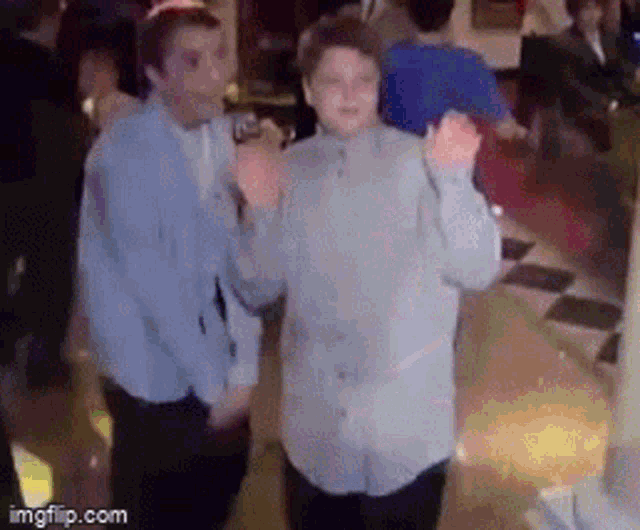 a couple of people are dancing in a room with a watermark that says imgflip.com .