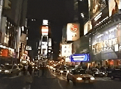 a busy city street at night with a burger king sign in the background