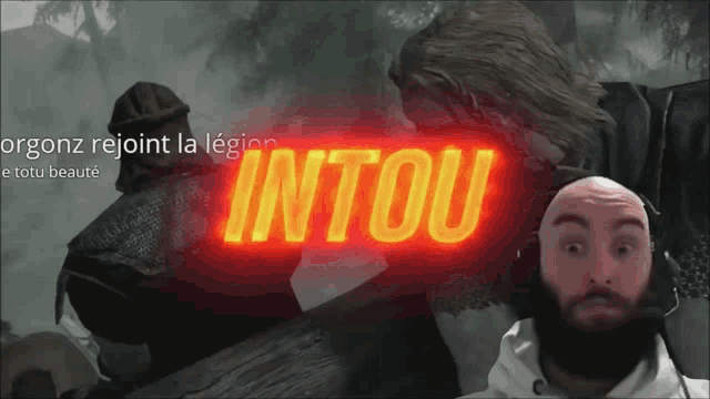 a man with a beard is looking at a screen that says intou on it