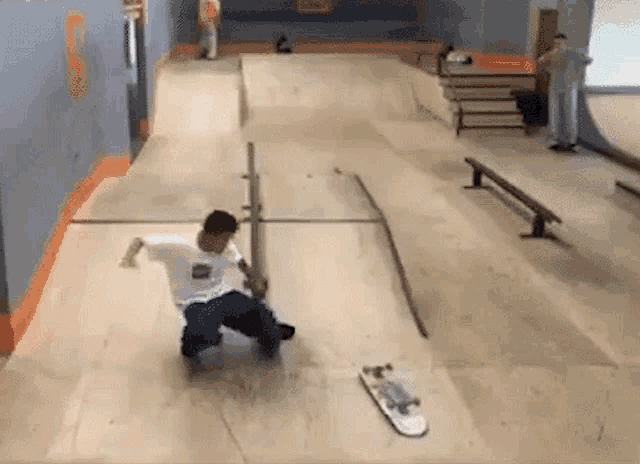 a young boy is riding a skateboard on a ramp at a skate park .