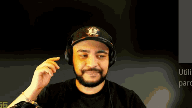 a man wearing headphones and a hat with the number 8 on it