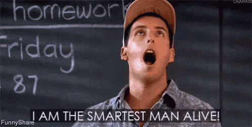 a man is standing in front of a blackboard with his arms outstretched and says i am the smartest man alive !