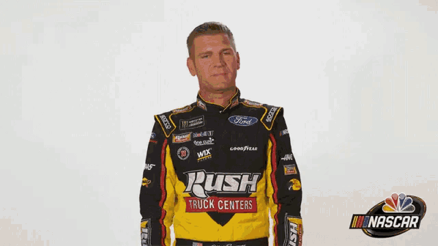 a man in a rush truck centers racing jacket covering his face