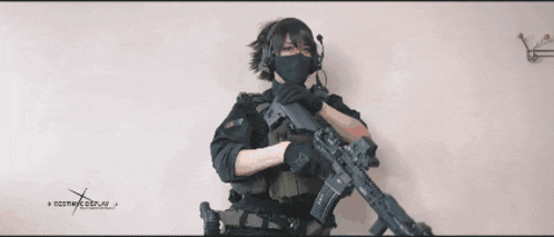 a person holding a rifle with a website written on the bottom of the image