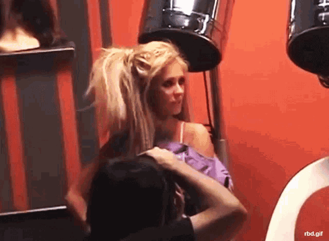 a gif of a woman getting her hair done with the url rbd.gif visible