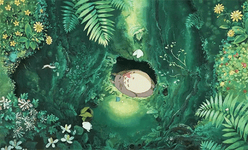 a cartoon totoro is sleeping in a hole in a tree