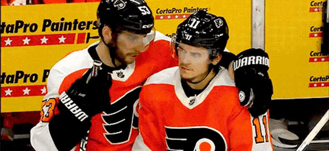 two hockey players are standing next to each other with one wearing number 11
